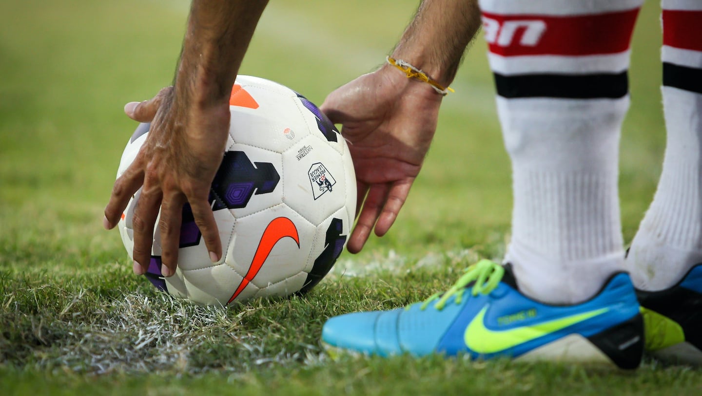 Nike sneaker with a football