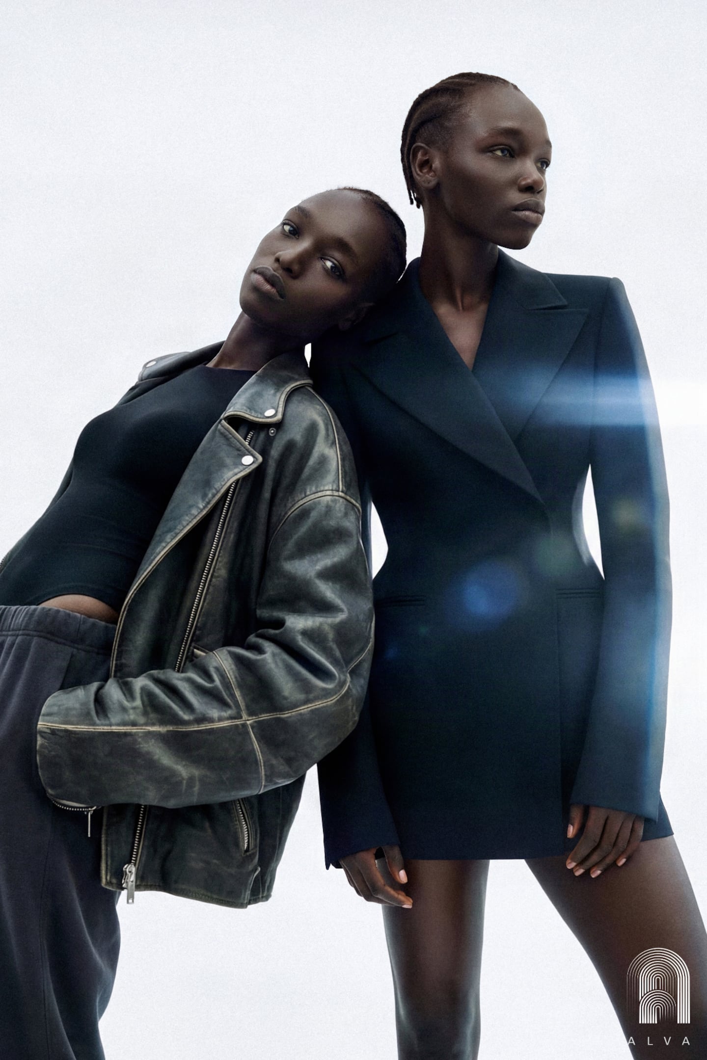 Two versions of model Nyajuok Gatdet pose for a photograph, one in a double breasted blazer and the other in a leather jacket and bodysuit.