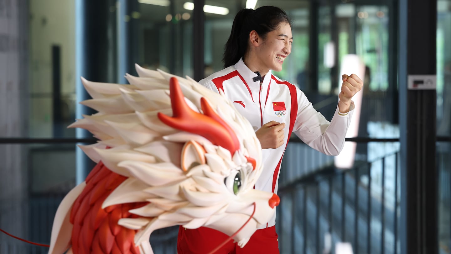 Chinese boxer Li Qian shows off the medal ceremony uniform, supplied by local sportswear brand Anta, for the Chinese delegation at the Paris 2024 Summer Olympic Games at an unveiling ceremony on June 25, 2024 in Beijing, China.