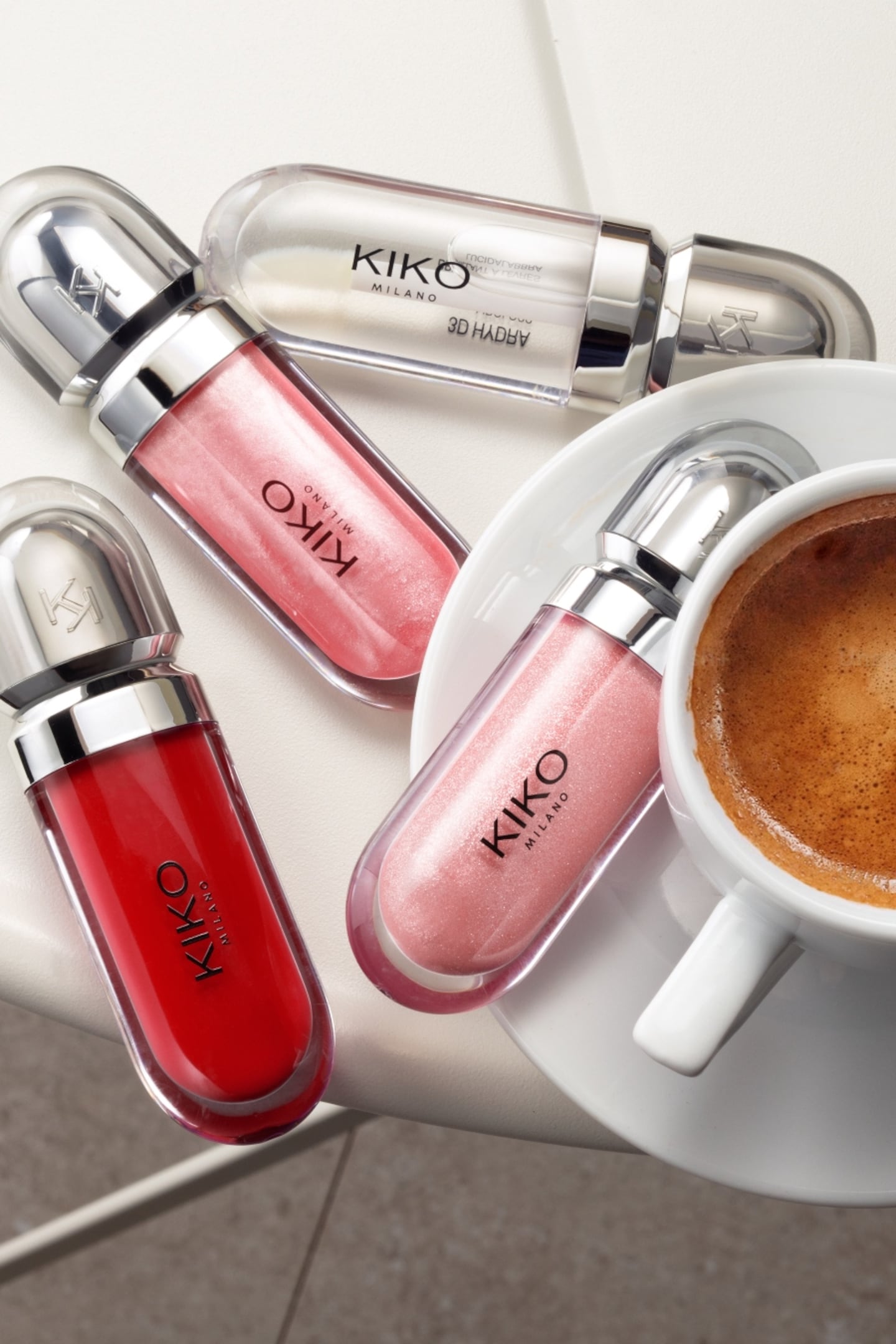 Lipglosses and a cup of coffee on a table